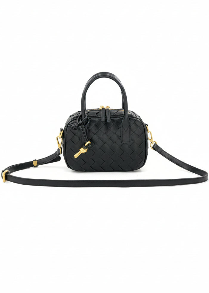 Black handbag with a strap on a white background