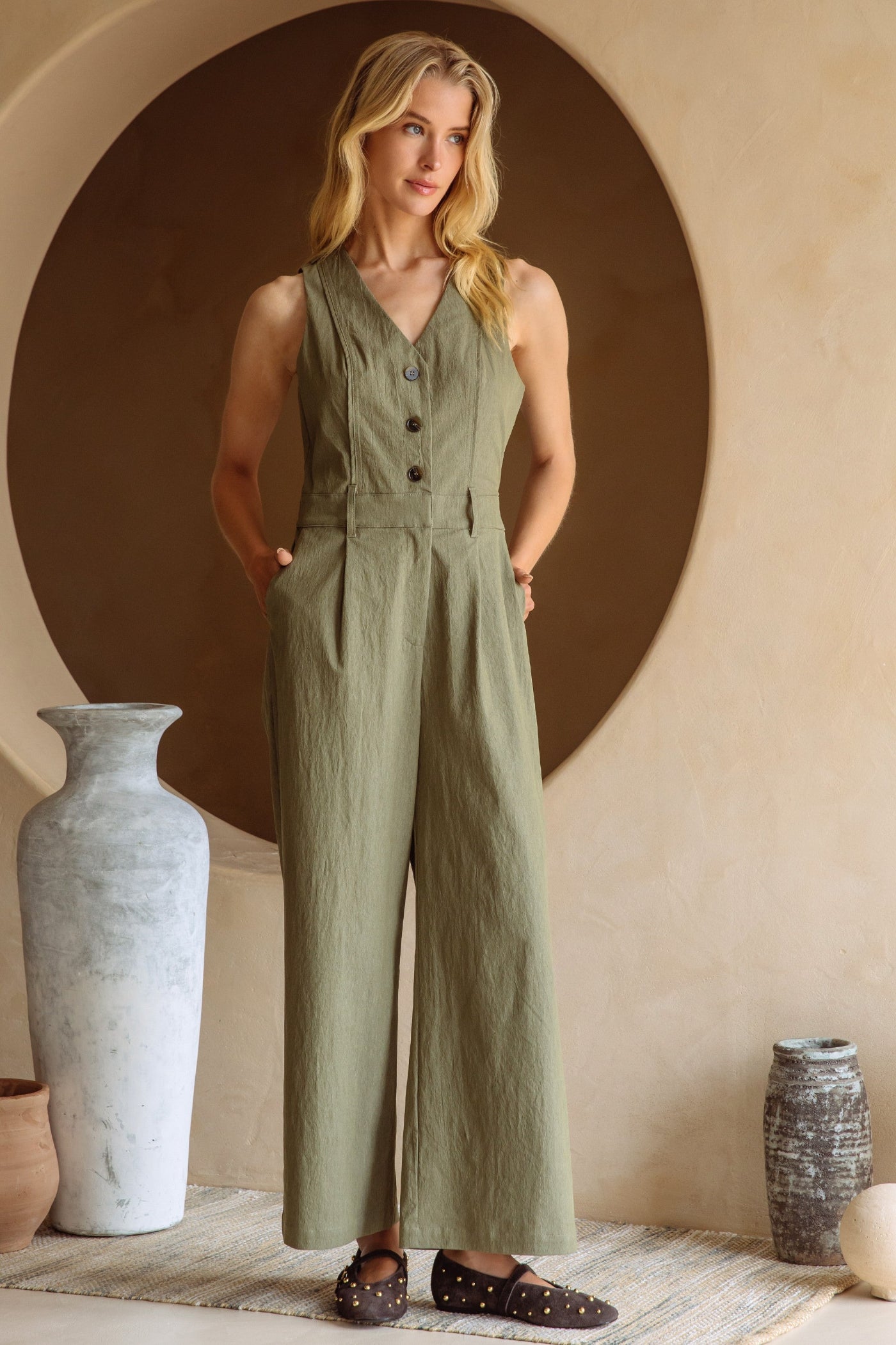 SKIES ARE BLUE BUTTON DOWN JUMPSUIT WITH CUTOUT BACK – AN OLIVE JUMPSUIT WITH A RELAXED FIT AND STYLISH BACK DETAIL