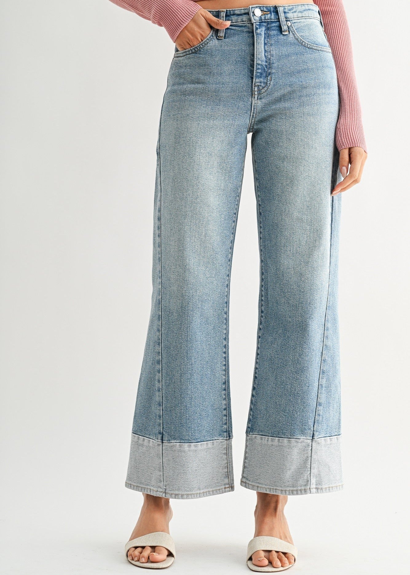 Light blue wide-leg jeans two toned hem worn by a person on a white background
