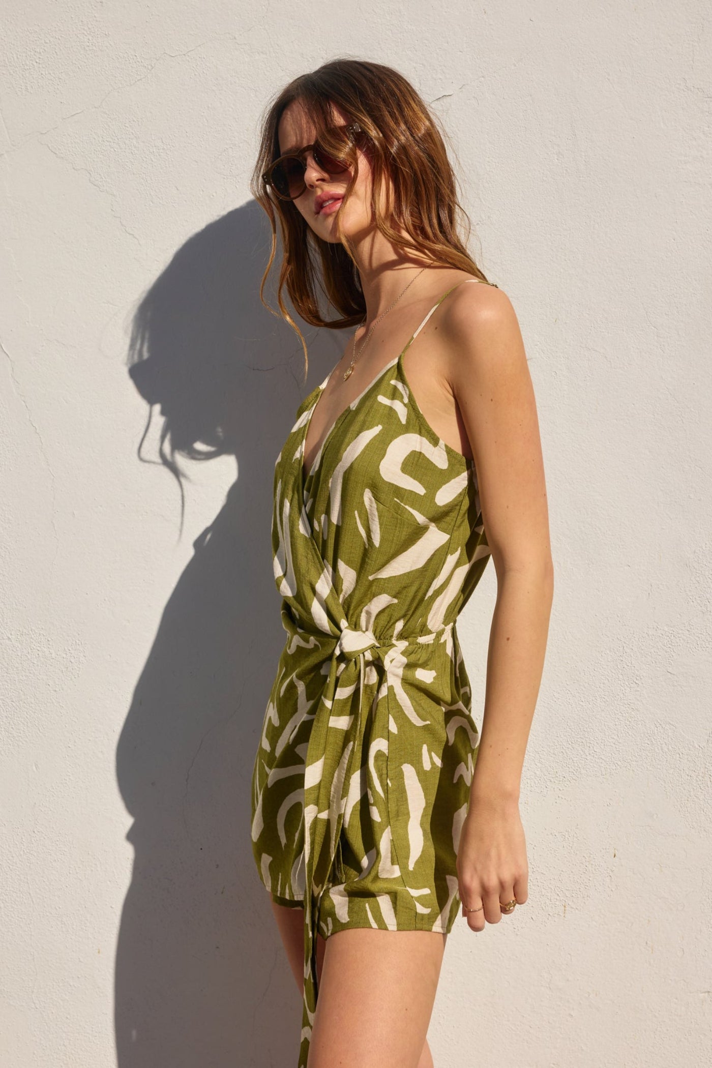 DRESS FORUM TROPICAL TWIST TIE-WAIST ROMPER – A WRAP-STYLE OLIVE ROMPER WITH A FLATTERING FIT AND ABSTRACT PRINT