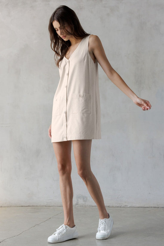 STORIA SAND V-NECK MINI DRESS – A SLEEVELESS, BUTTON-FRONT MINI WITH UTILITY CHARM