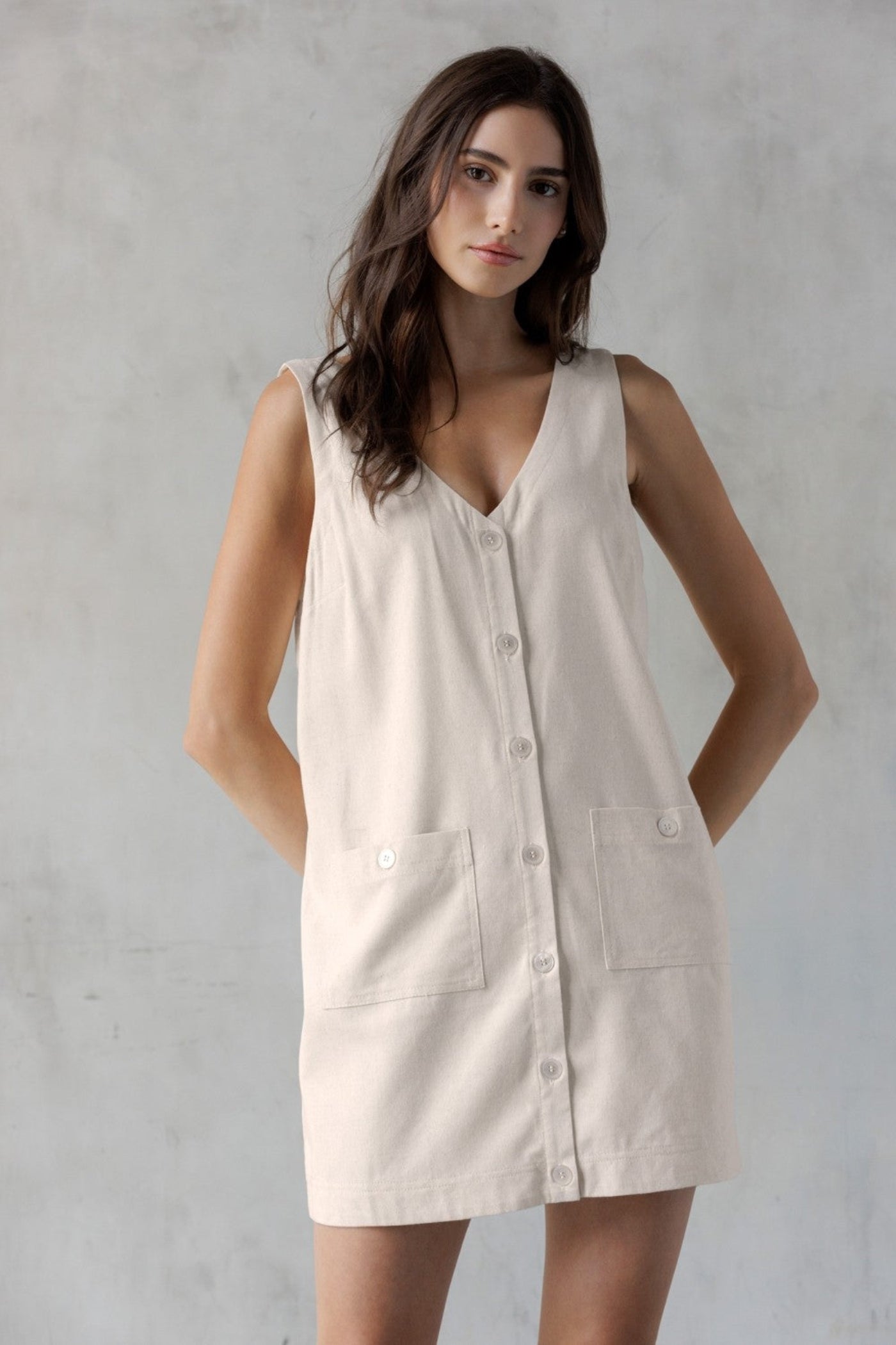 STORIA SAND V-NECK MINI DRESS – A SLEEVELESS, BUTTON-FRONT MINI WITH UTILITY CHARM
