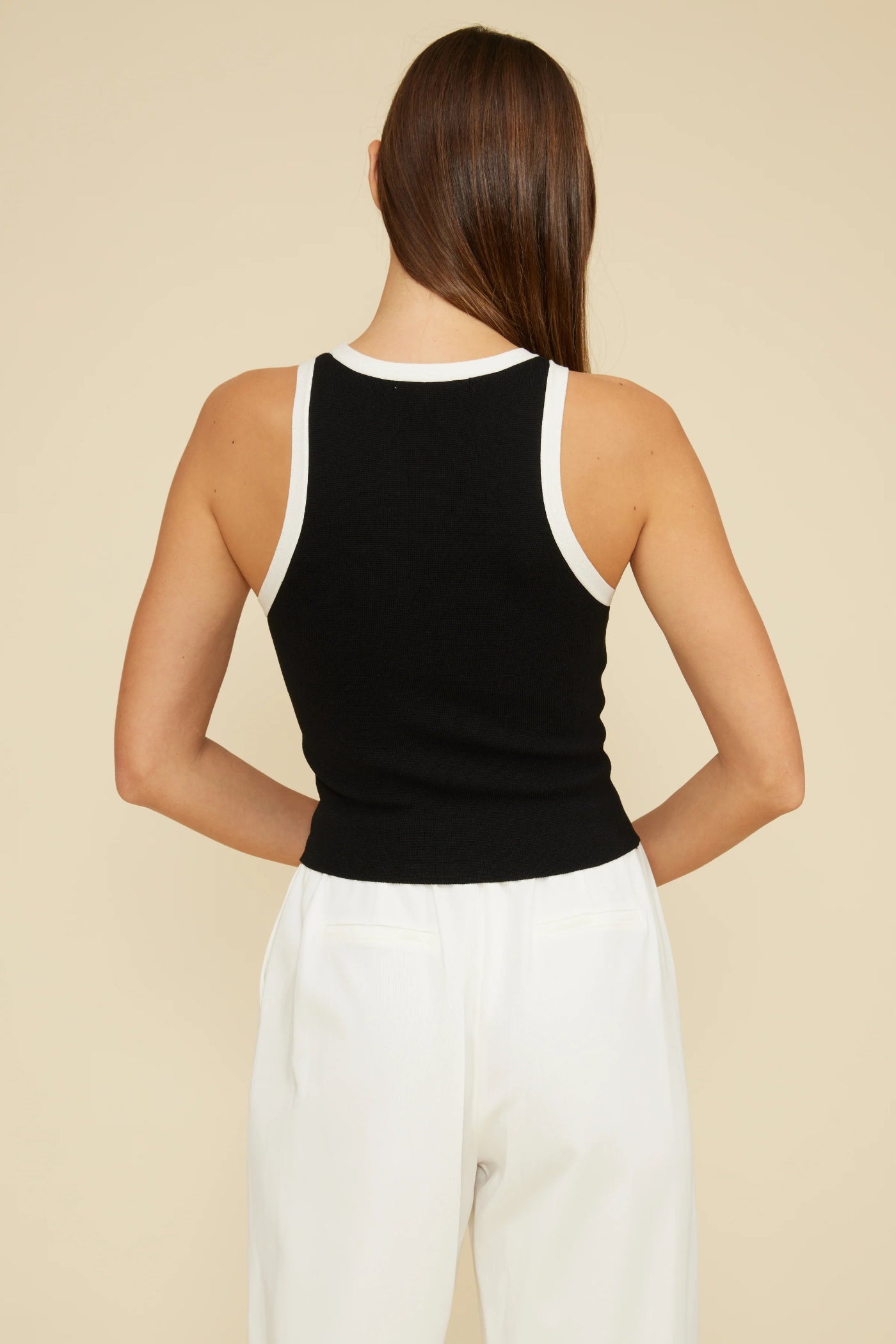 LUCY PARIS BRANDI CUTAWAY TANK TOP – A SLEEK BLACK TANK WITH WHITE TRIM AND A MODERN SILHOUETTE